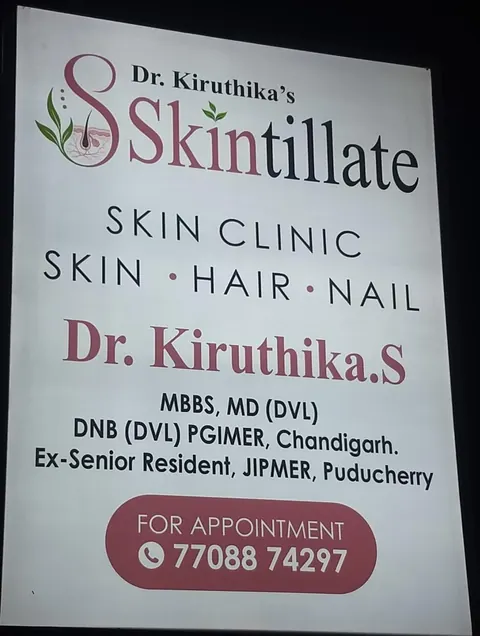 Illuminated Skintillate Skin Clinic signboard showing Dr. Kiruthika S. and the appointment number