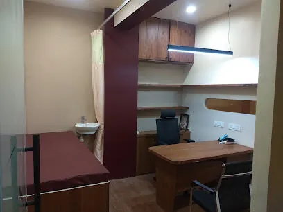 Consultation room with doctor's desk and examination couch